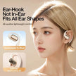 Woman wearing white ear-hook wireless earphones, comfortable fit for all ear shapes