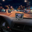 Car dashboard with night driving monitor displaying road and traffic camera view