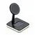 Black magnetic wireless charging stand for smartphones on a white background