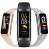 Three smart fitness trackers with color displays and silicone bands in black, pink, and silver