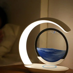 Modern LED night lamp with circular sand art on a bedside table