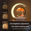 Modern crescent LED sand art lamp on table with adjustable brightness settings display