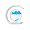 Modern white sand art lamp with blue moving sand in circular frame on white background