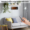 Remote control operating large digital wall clock in modern living room with sofa and plants
