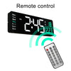 Digital wall clock with large LED display and remote control, showing time and temperature.