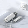 White portable handheld vacuum cleaner charging on tabletop with brush attachment