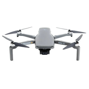 Gray DJI Mini SE drone with camera and four propellers on a white background