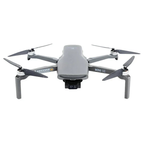 Gray DJI Mini SE drone with camera and four propellers on a white background