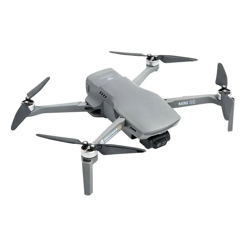 Gray DJI Mini SE drone with four propellers on white background