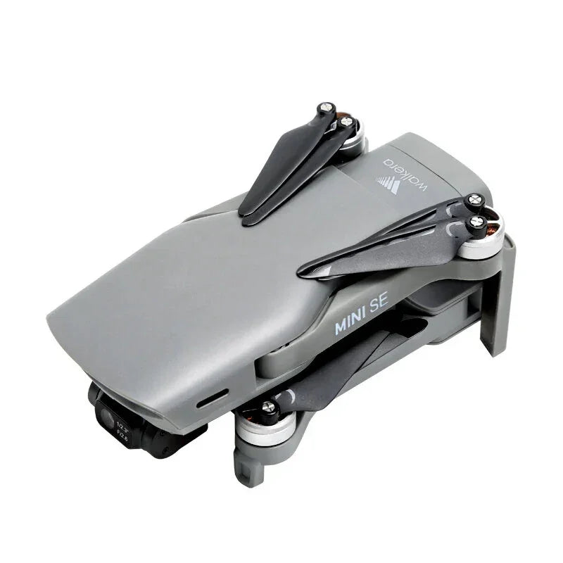 Folded gray Mini SE drone with black propellers on white background