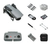 Foldable drone kit with remote controller, propellers, battery, charger, SD card, tools, carrying case.