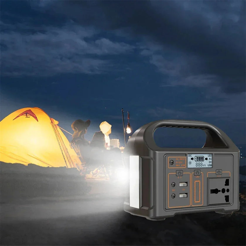 Portable power station lighting up campsite with tent and two people at night outdoors