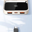 Modern power bank with digital display, dual USB ports, USB-C cable on light surface