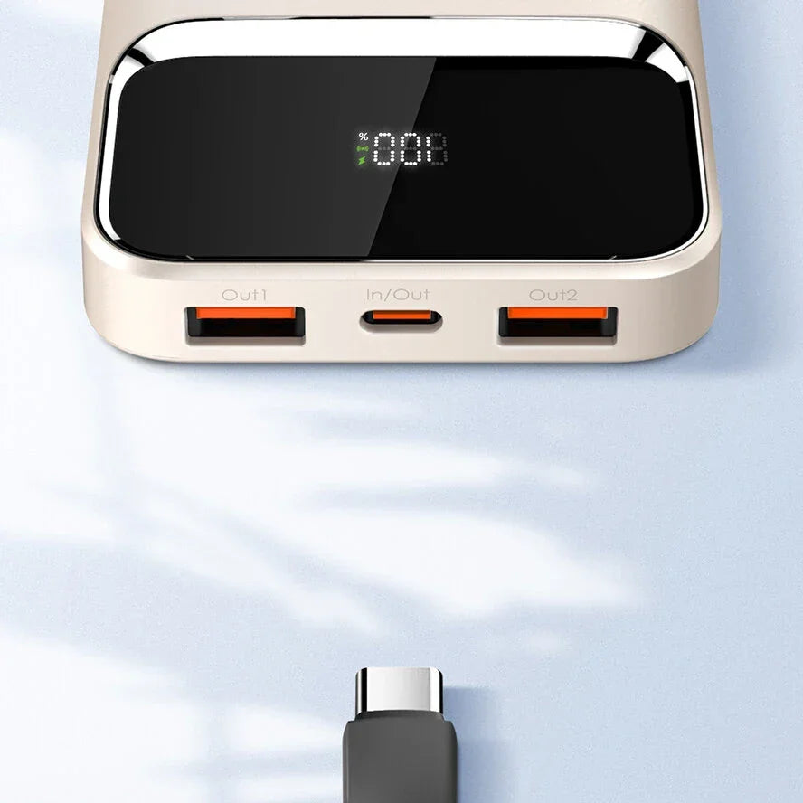 Modern power bank with digital display, dual USB ports, USB-C cable on light surface