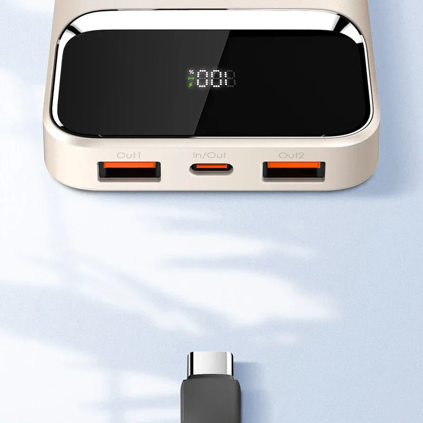 Modern power bank with digital display, dual USB ports, USB-C cable on light surface