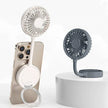 Portable mini phone fan with stand in white and gray, attached to smartphone and displayed on platform