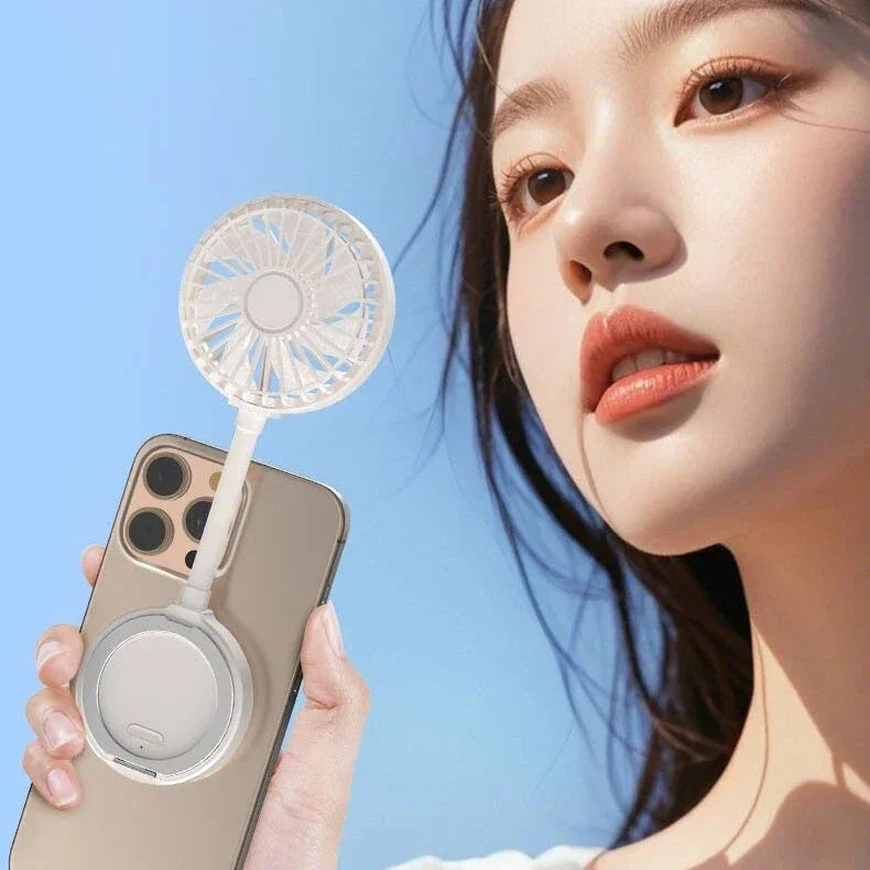 Woman holding phone with attached portable mini fan, blue sky background