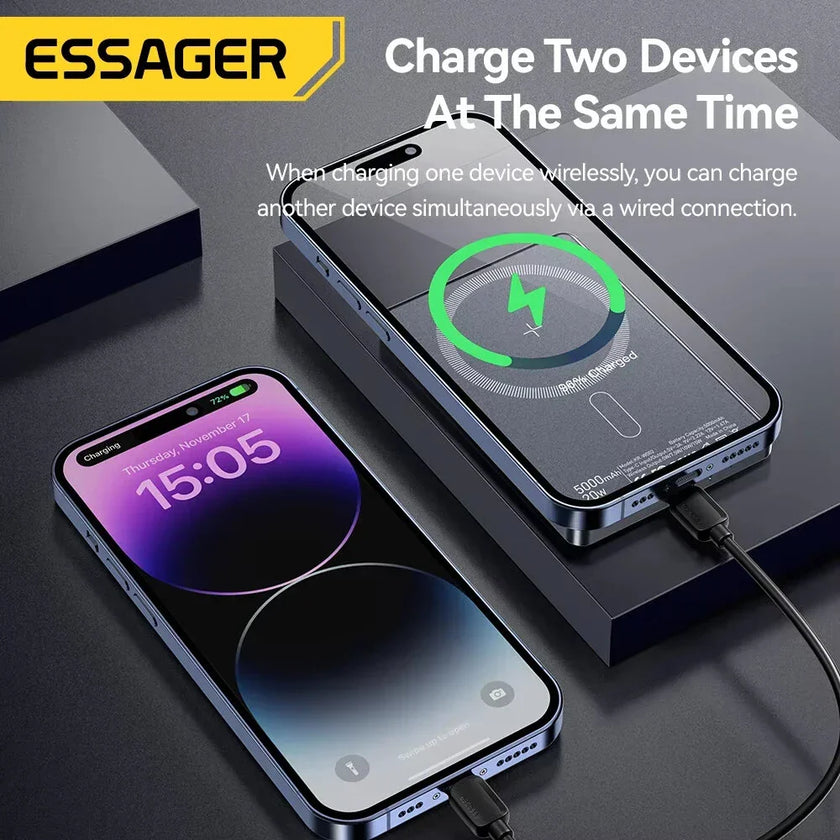ESSAGER power bank charging two smartphones at once, wireless and wired, on a dark desk