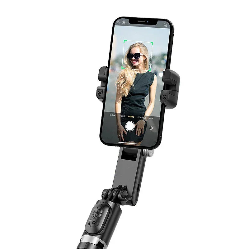 Smartphone on selfie stick with camera app and woman in sunglasses on screen