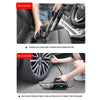 Person using portable car vacuum cleaner on seat and inflating car tire with same device
