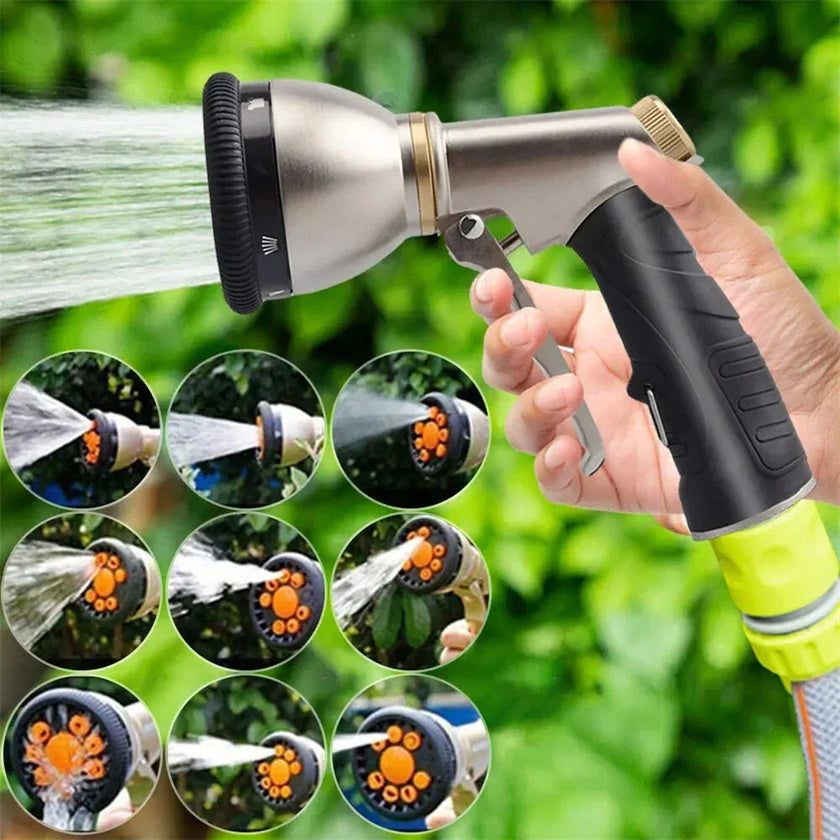Adjustable garden hose spray nozzle with multiple water settings against green foliage
