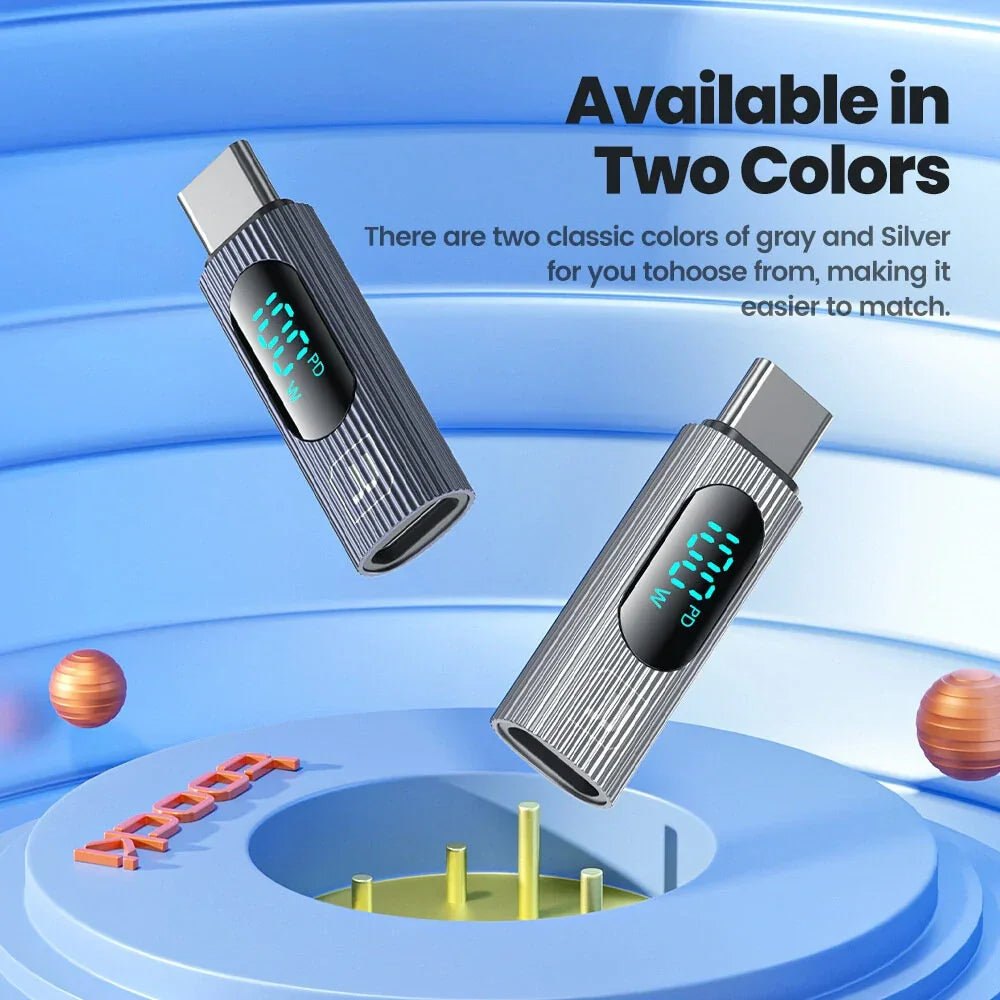 Two USB-C power meters with digital display, gray and silver, on a blue background.