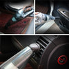 Handheld car vacuum cleaner used on car mat, door panel, and air vent for interior cleaning