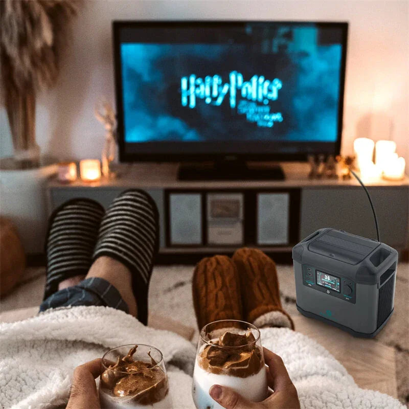 Couple in slippers watching Harry Potter on TV, cozy blankets, portable power station, dessert drinks