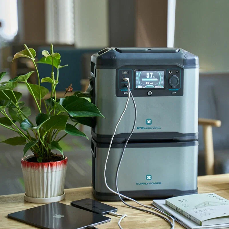 Portable power station charging devices on table with plant and books, modern home setting