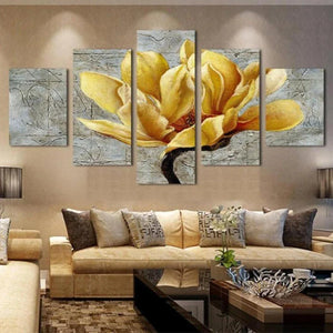 Modern living room with beige sofas, yellow flower canvas wall art, and decorative pillows