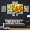 Modern living room with multi-panel yellow magnolia flower wall art above a patterned sofa
