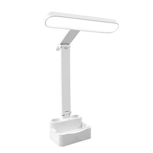 Modern white LED desk lamp with touch control and storage base on white background