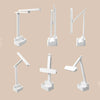 Adjustable white LED desk lamp with storage base shown in six positions on beige background