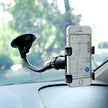 Car dashboard phone holder with smartphone displaying map navigation app