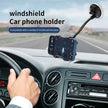 Windshield car phone holder with GPS navigation, mounted on dashboard in moving vehicle