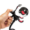 Hand holding black and red flexible phone holder clamp with close-up on padded grip.