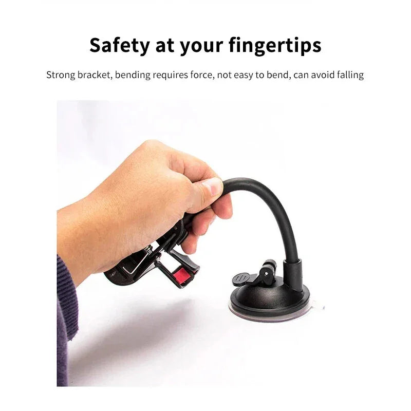 Hand holding flexible black phone mount with suction cup base on white background